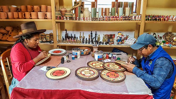 A local couple painstakingly add the final details to their beautiful ceramics