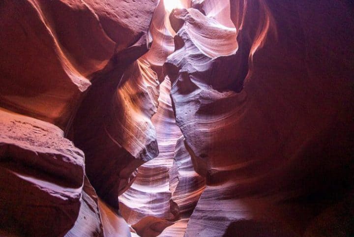 Antelope Canyon is a slot canyon located about 2 hours north of the Grand Canyon and it is just outside a town called Page