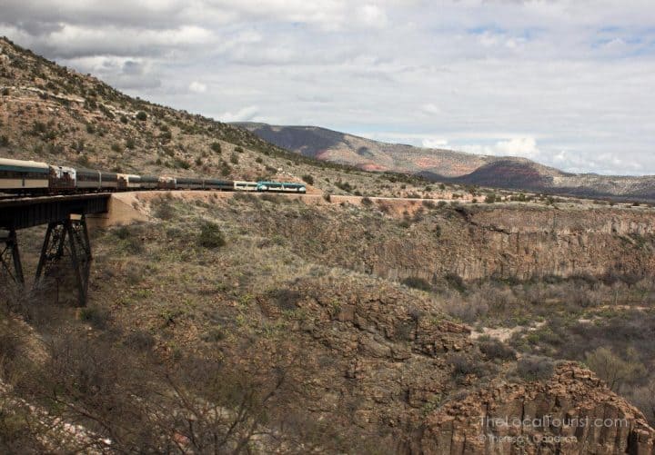 The Verde Canyon Railroad excursion train is a four-hour tour along a river, alongside red rocks, and between two National Forests