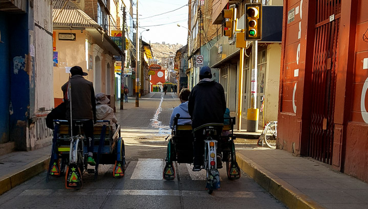 A race around the backstreets of Puno on pedicabs