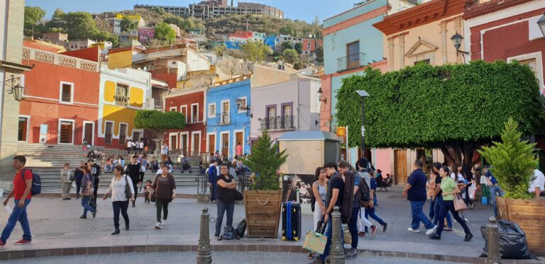 people walking through a plaza in the centre of Guanajuato