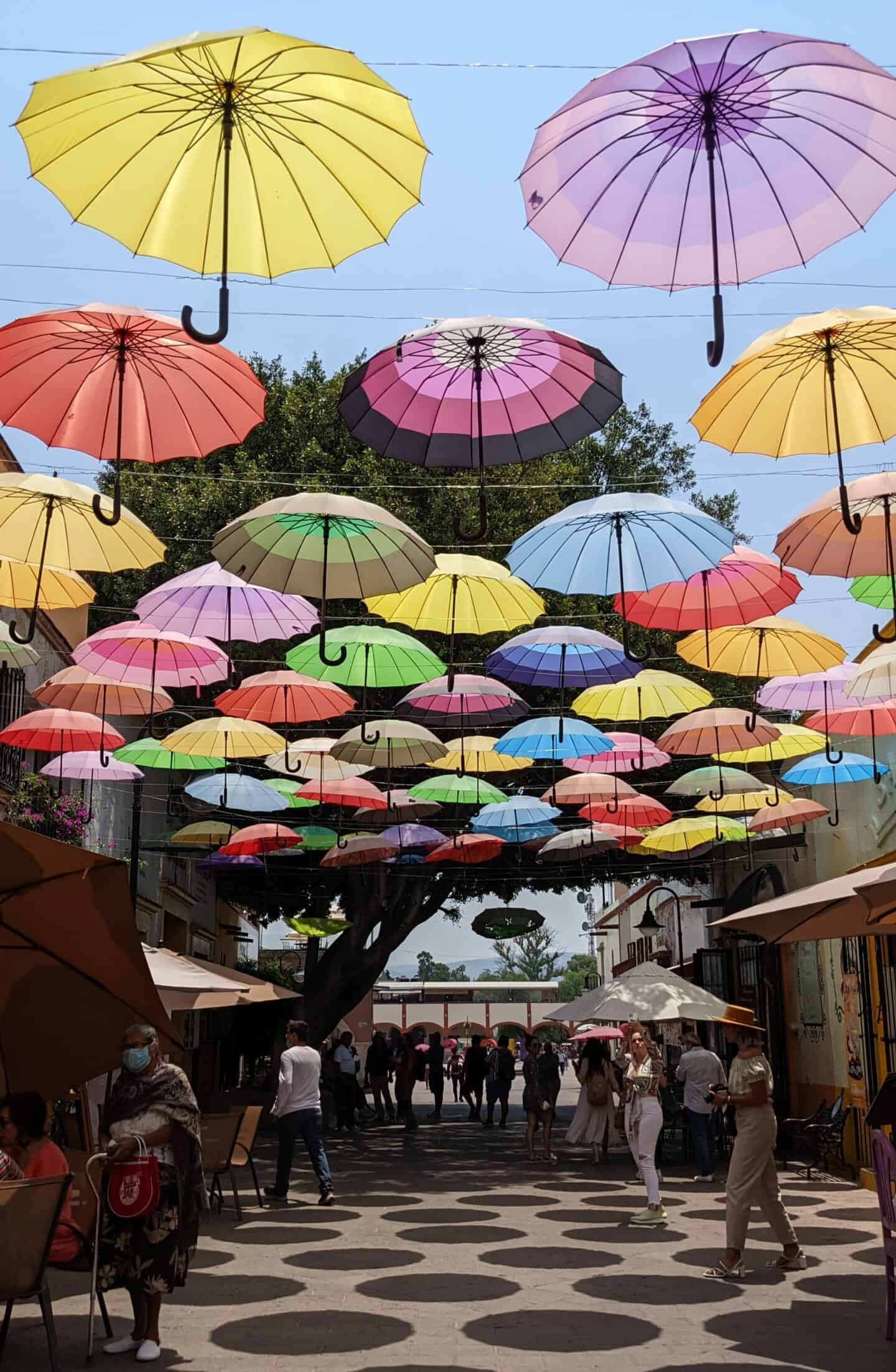 a street in Tequisquiapan Mexico covered with colourful umbrellas