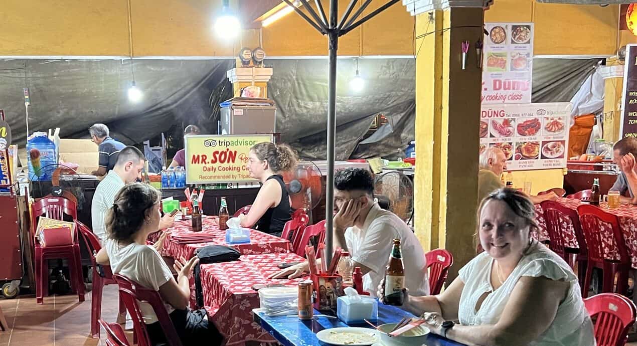 Pauline at the sidewalk table at Mr Son in Hoi An