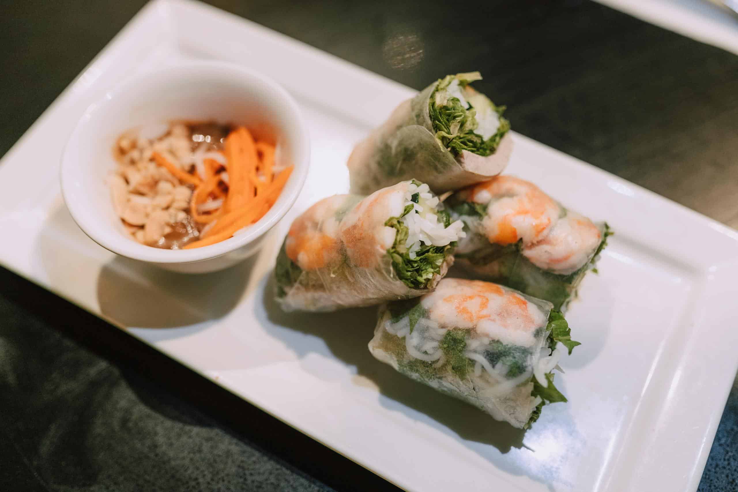 Vietnamese summer rolls on a plate with dipping sauce